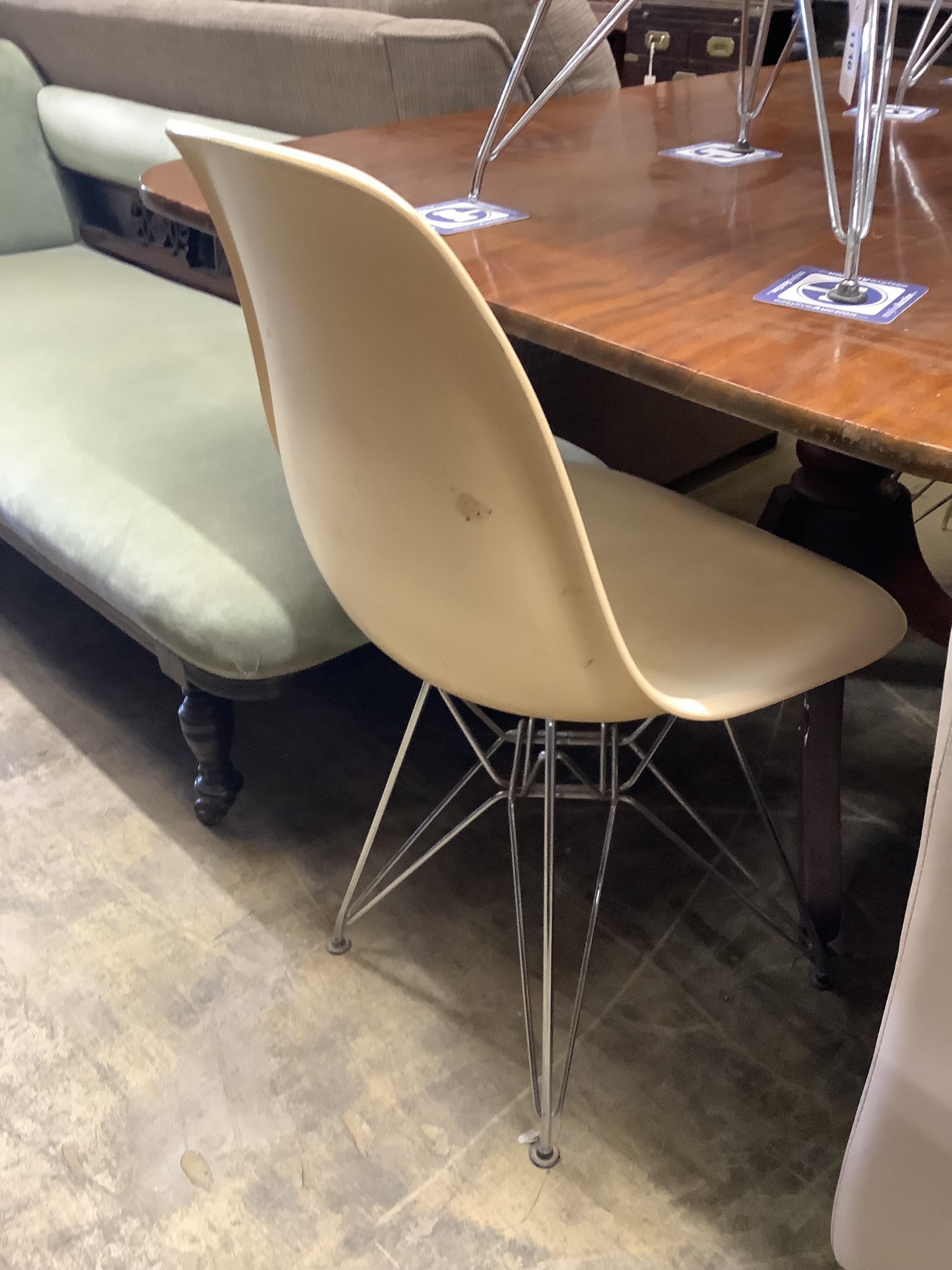 A set of four Eames fibre glass Eifel base chairs
